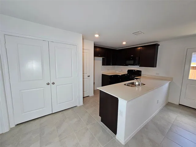 a kitchen with a sink and a refrigerator