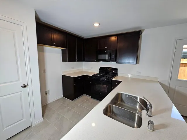 a kitchen with a sink and a refrigerator