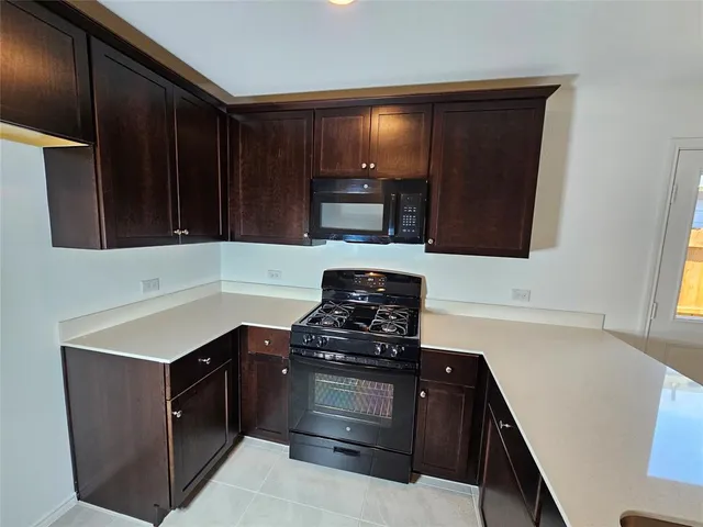 a kitchen with a stove and a microwave