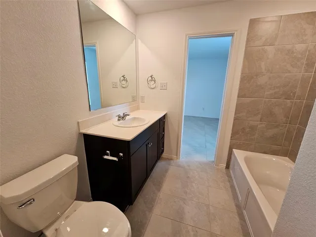 a bathroom with a sink a toilet and tub