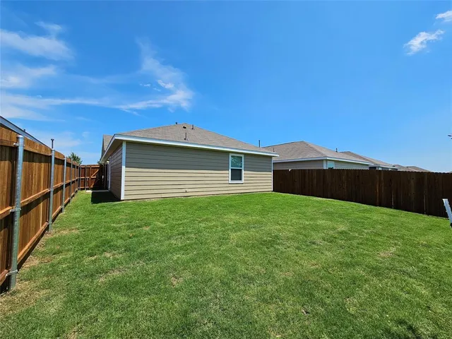 a view of a backyard with potted plants