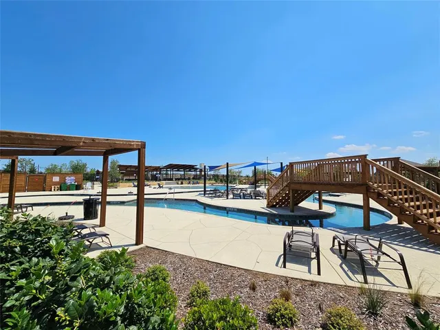 a view of a swimming pool with an outdoor seating and a terrace