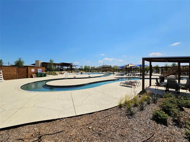 a view of a swimming pool with an outdoor seating