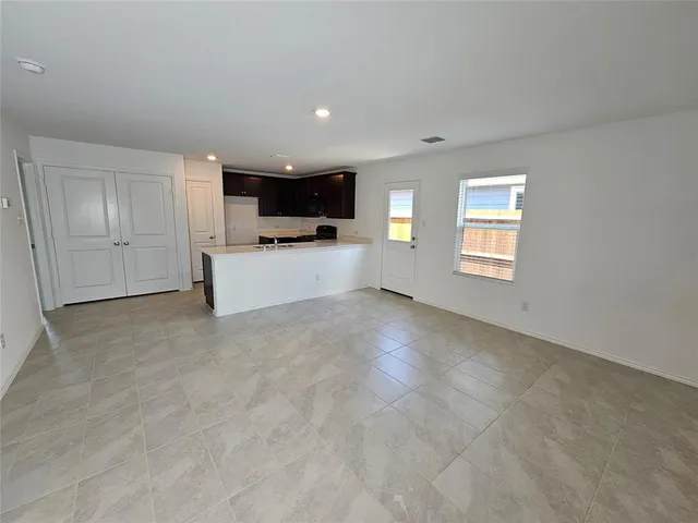 a view of a livingroom with furniture and a window