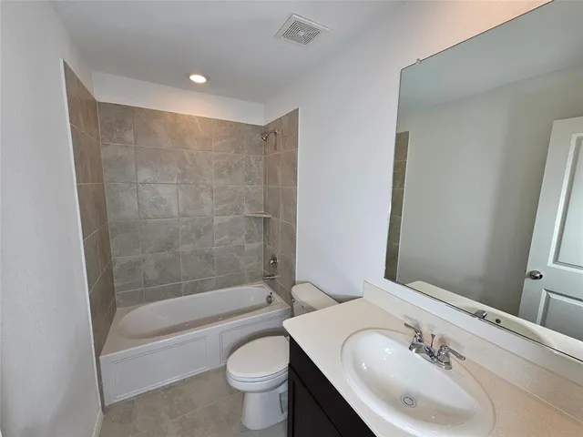 a bathroom with a sink mirror toilet and bathtub