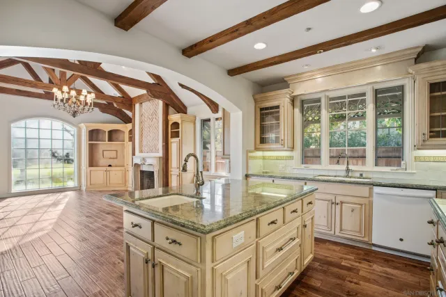 a kitchen with stainless steel appliances granite countertop a stove and a sink