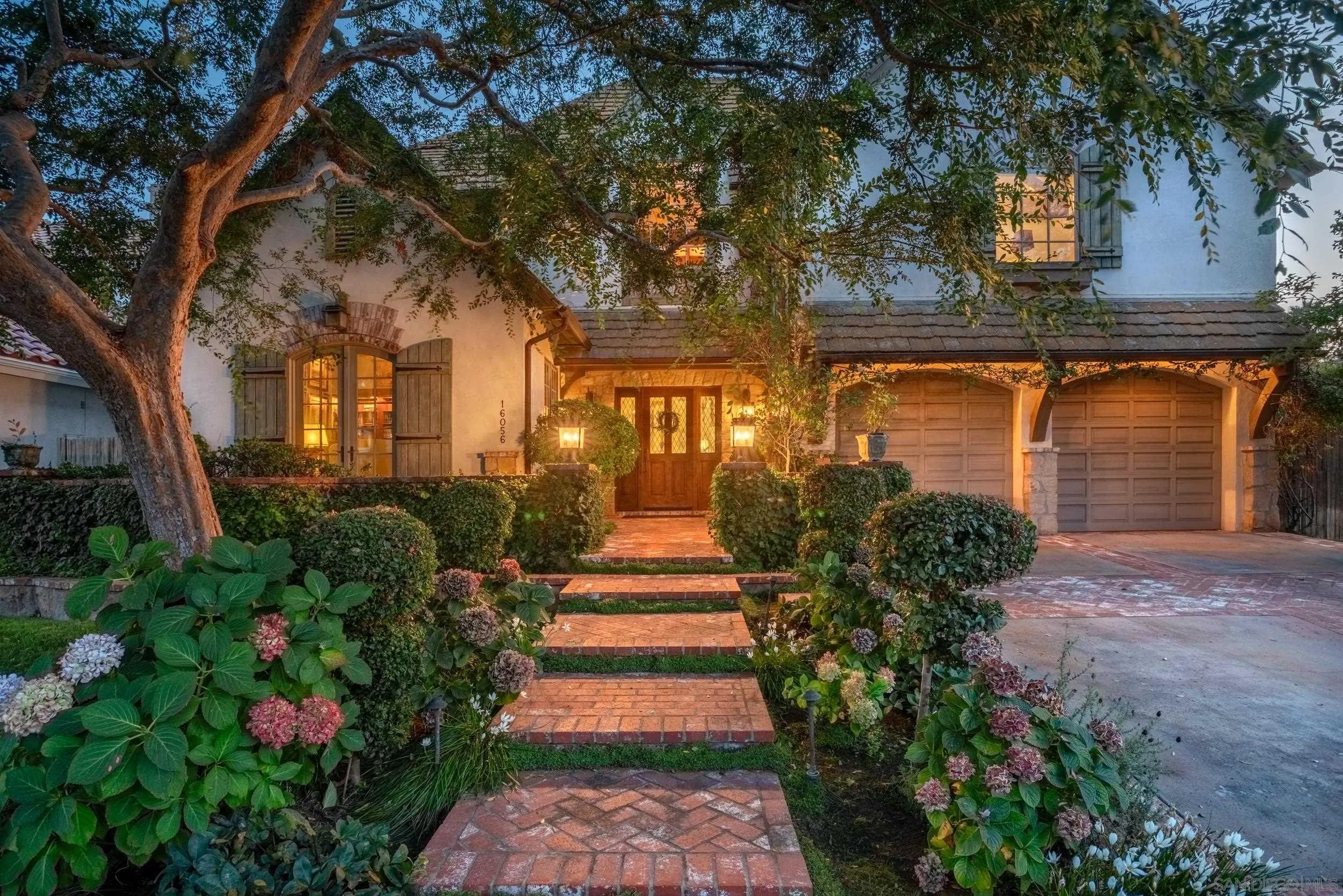 16056 Avenida Calma Rancho Santa Fe, CA 92091 - Photo 2 of 51 a front view of a house with a yard and fountain in middle