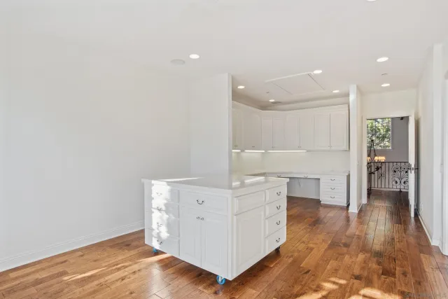 a view of cabinets with wooden floor and window