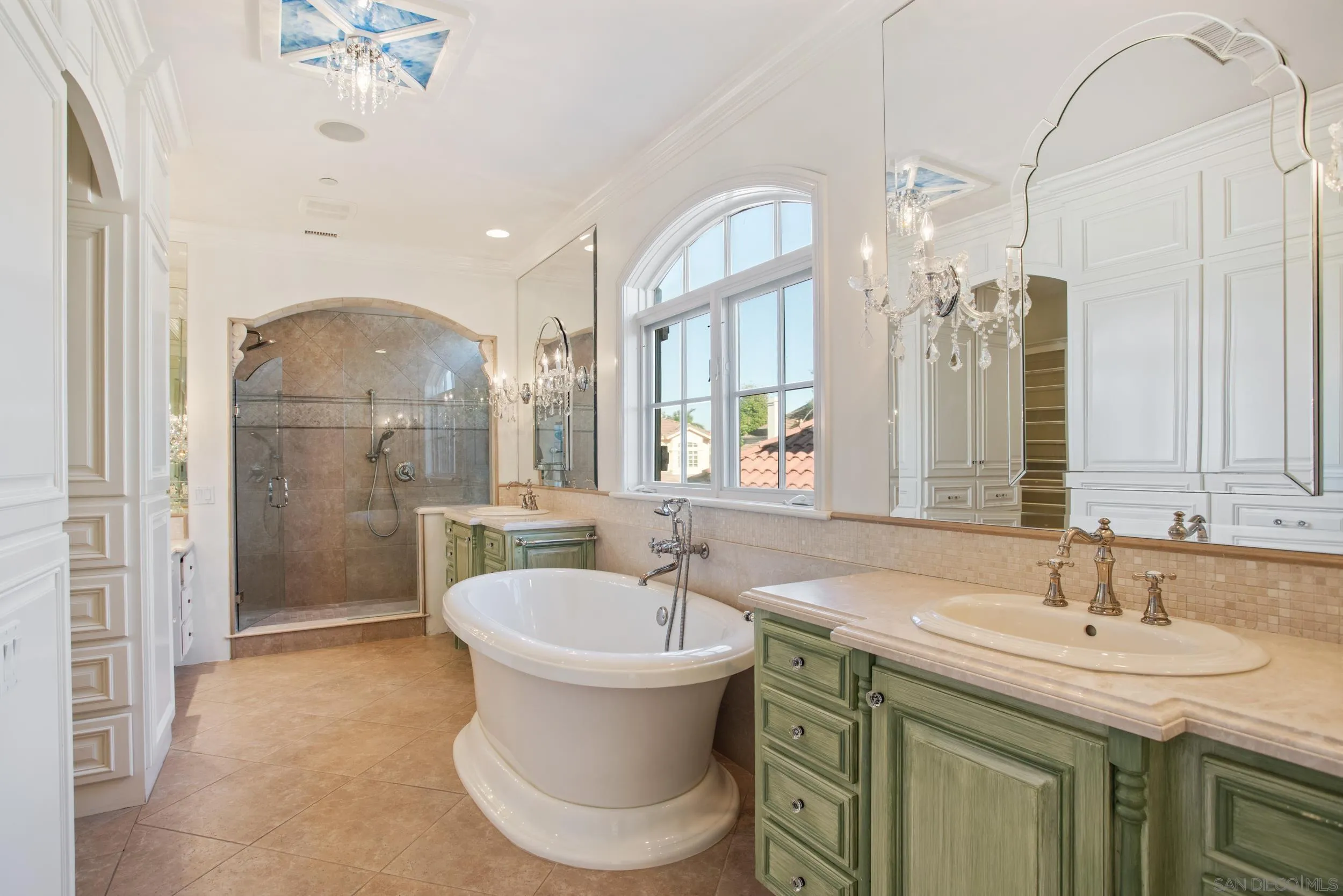 16056 Avenida Calma Rancho Santa Fe, CA 92091 - Photo 28 of 51 a spacious bathroom with a sink a toilet a mirror and shower