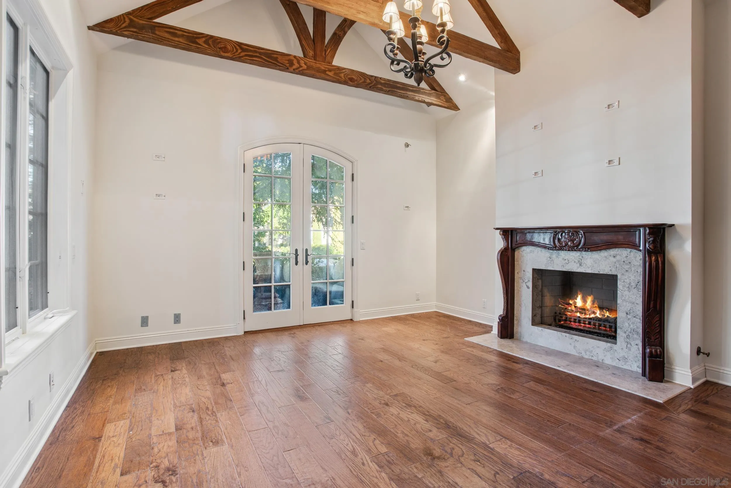 16056 Avenida Calma Rancho Santa Fe, CA 92091 - Photo 36 of 51 a view of an empty room with wooden floor fireplace and a window
