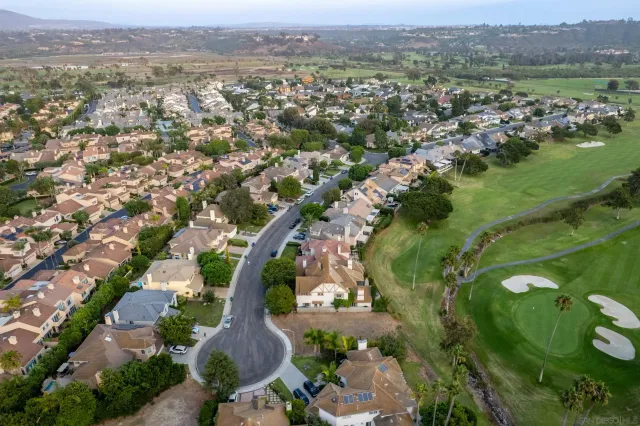 an aerial view of residential houses with outdoor space and river