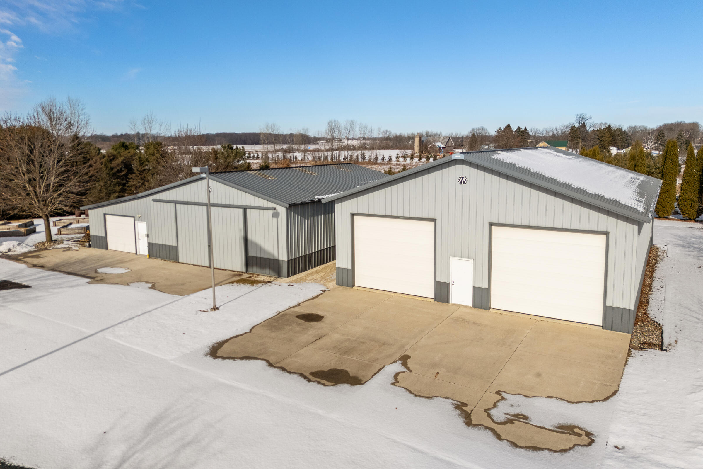 8520 South Gass Lake Road Newton, WI 53063 - Photo 4 of 28 Right: 60’ x 42’ pole building with concrete floor and three powered overhead doors Left: 50’ x 36’ pole building with large sliding doors + 20’ x 50’ licensed winery production addition