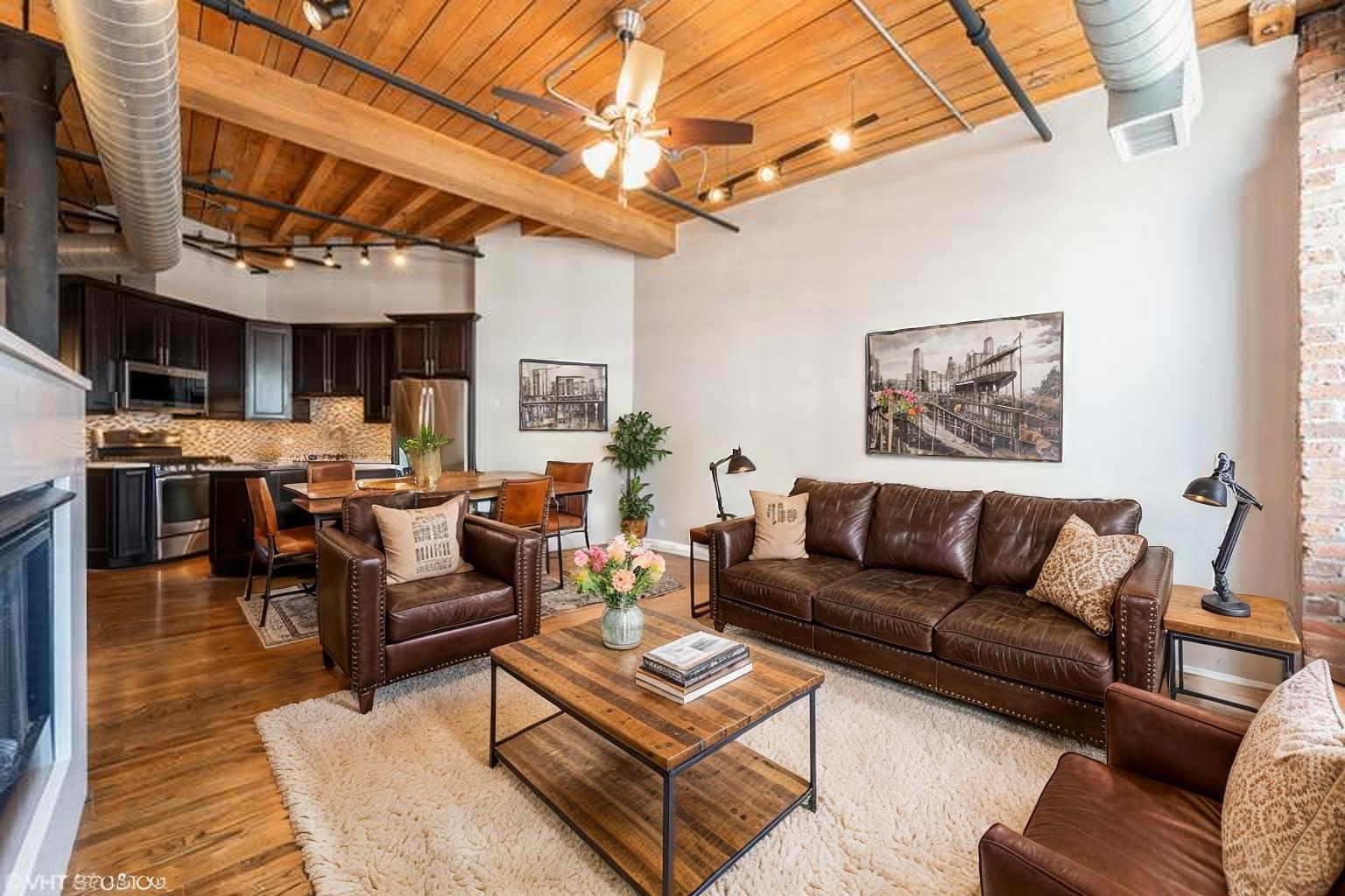 420 South Clinton Street, Unit 617A Chicago, IL 60607 - Photo 4 of 25 a living room with furniture a fireplace and a kitchen view