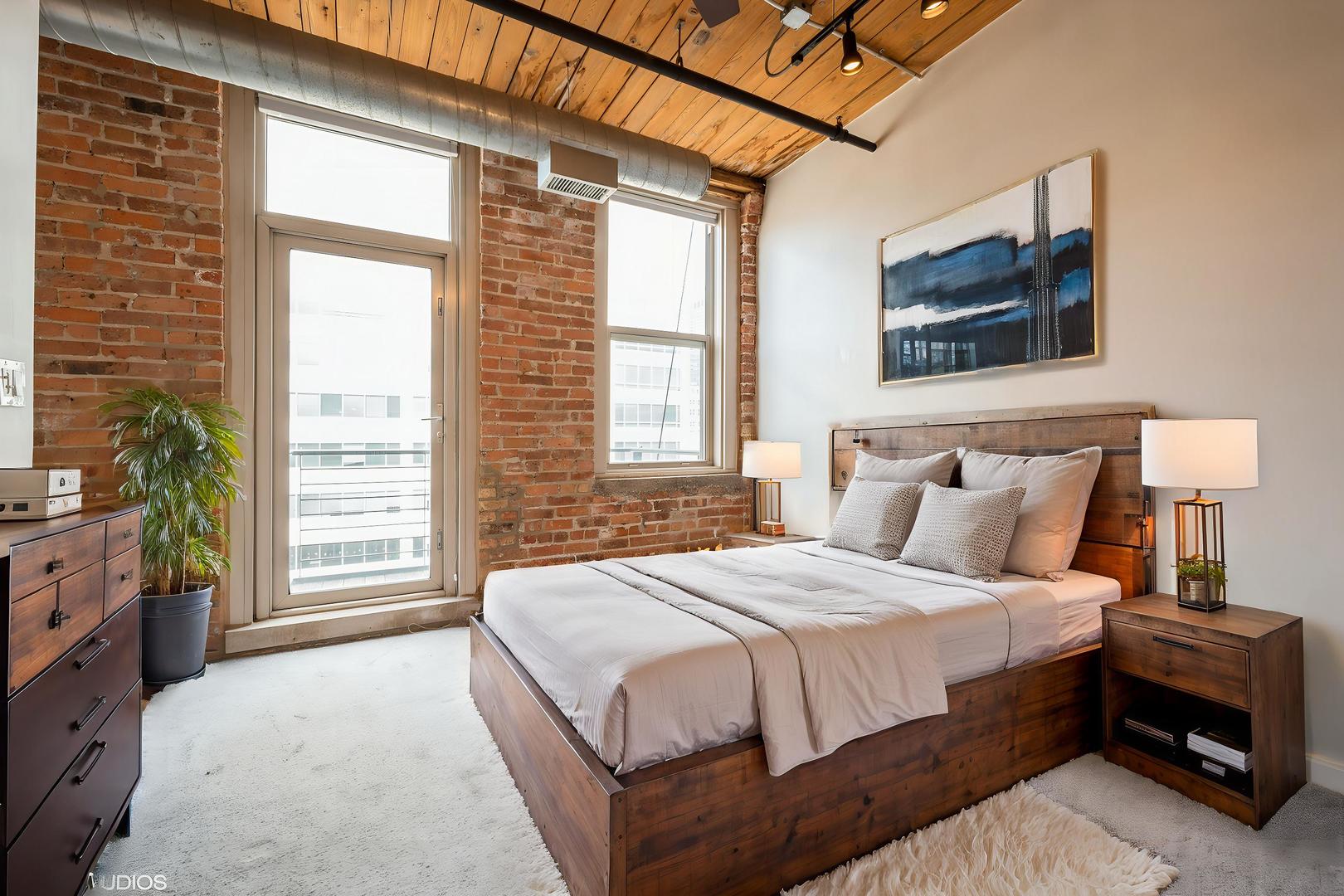 420 South Clinton Street, Unit 617A Chicago, IL 60607 - Photo 10 of 25 a bedroom with a bed a dresser next to a window