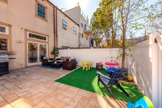 a view of a house with backyard and sitting area