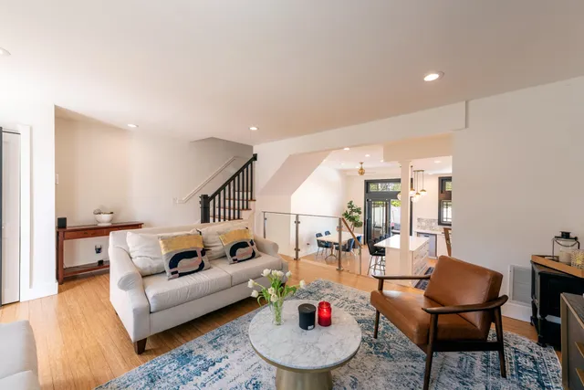a living room with furniture and wooden floor