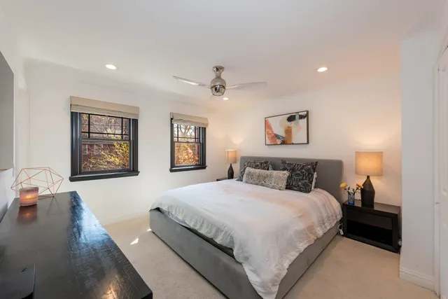a bedroom with a large bed and a chandelier