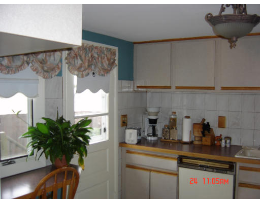 22 Eastmont Road Boston, MA 02136 - Photo 2 of 12 a kitchen with a potted plant on the counter and cabinets