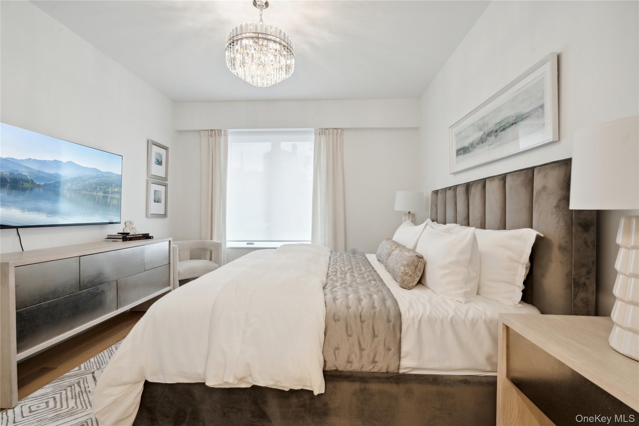 218 Middle Neck Road, Unit 101 Great Neck, NY 11021 - Photo 10 of 37 Bedroom featuring a notable chandelier and wood finished floors