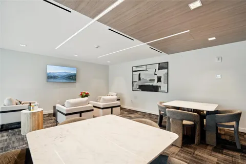 a living room with chairs and wooden floor