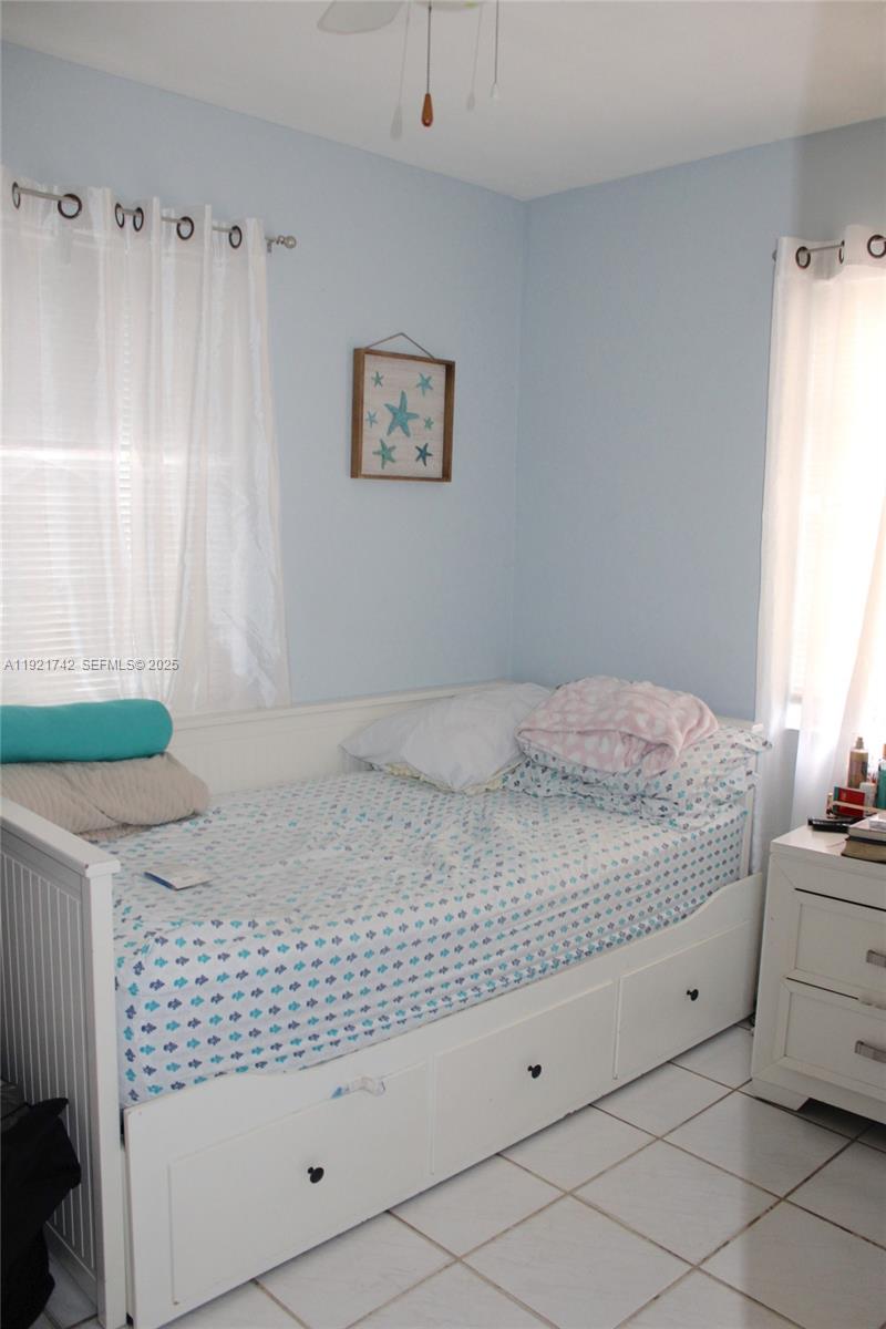 4940 Southwest 114th Avenue Miami, FL 33165 - Photo 16 of 31 a bedroom with a bed and a window