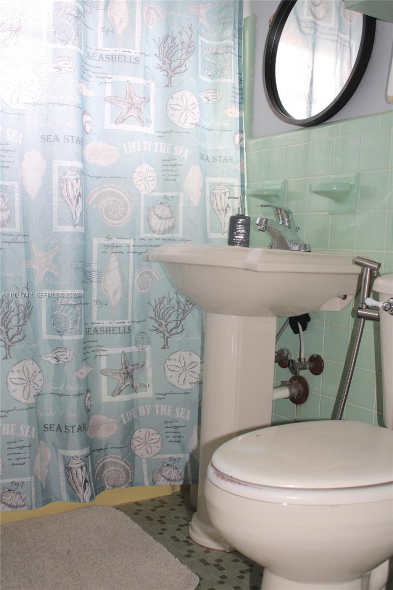 4940 Southwest 114th Avenue Miami, FL 33165 - Photo 17 of 31 a bathroom with a toilet and a mirror