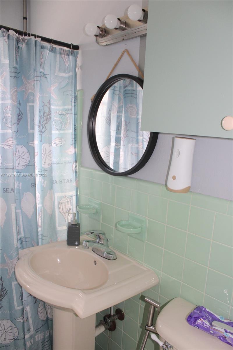 4940 Southwest 114th Avenue Miami, FL 33165 - Photo 18 of 31 a bathroom with a sink and a mirror