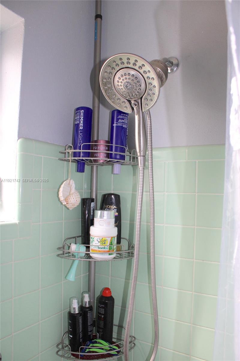 4940 Southwest 114th Avenue Miami, FL 33165 - Photo 20 of 31 a room with two chairs and a clock on the wall