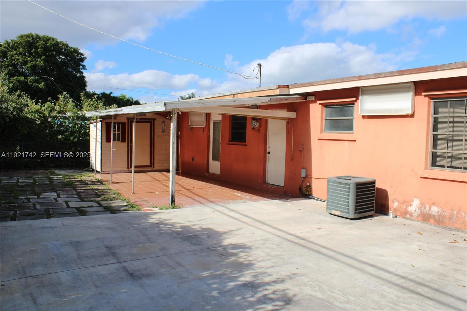 4940 Southwest 114th Avenue Miami, FL 33165 - Photo 22 of 31 a backyard of a house with barbeque oven and outdoor seating