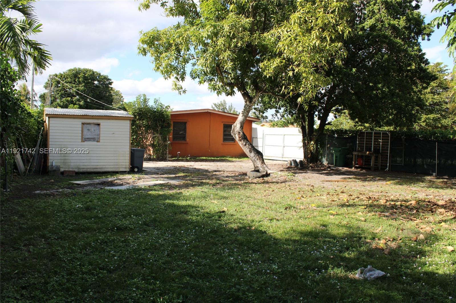 4940 Southwest 114th Avenue Miami, FL 33165 - Photo 25 of 31 a view of a house with a yard and large tree