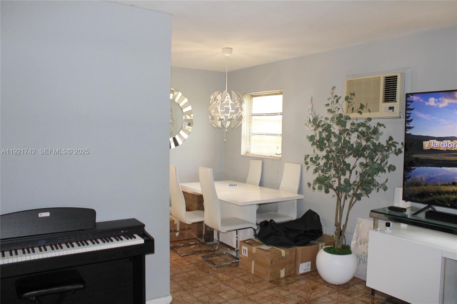 4940 Southwest 114th Avenue Miami, FL 33165 - Photo 9 of 31 a living room with furniture a window and a potted plant