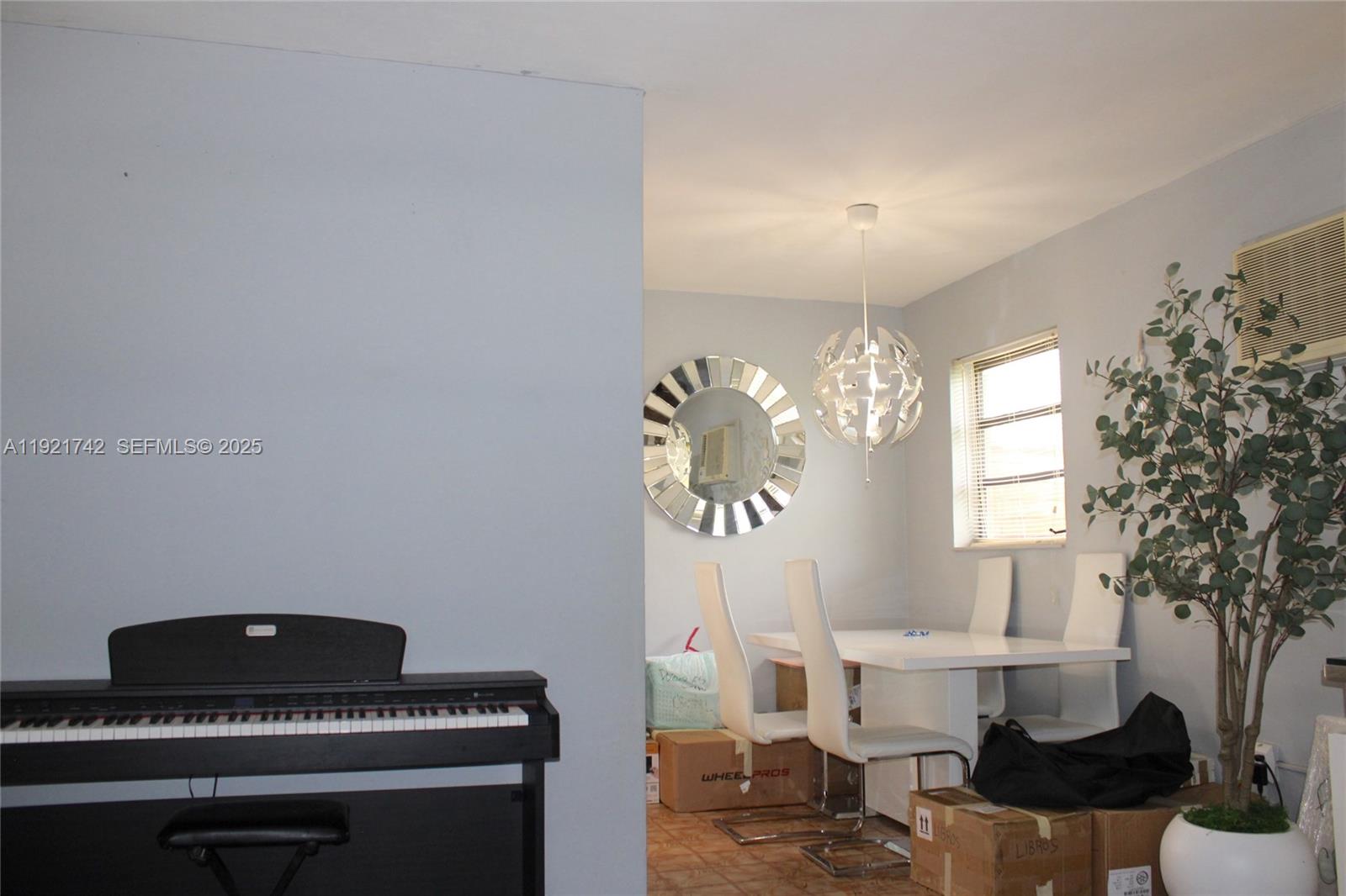 4940 Southwest 114th Avenue Miami, FL 33165 - Photo 10 of 31 a living room with furniture and a potted plant