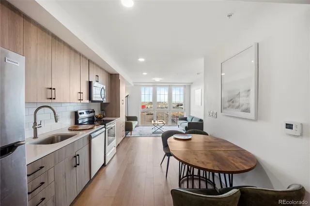 a kitchen with stainless steel appliances granite countertop a refrigerator sink and stove