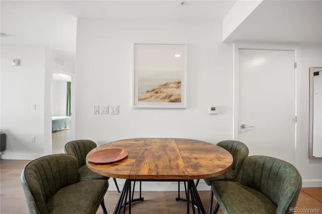 a bedroom with a bed and painting on the wall