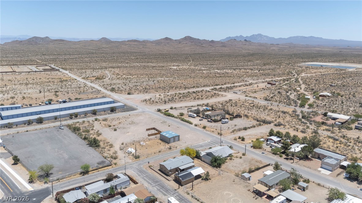 225 California Street Searchlight, NV 89046 - Photo 61 of 64 An aerial perspective reveals scattered residences amidst a vast, untamed desert landscape.