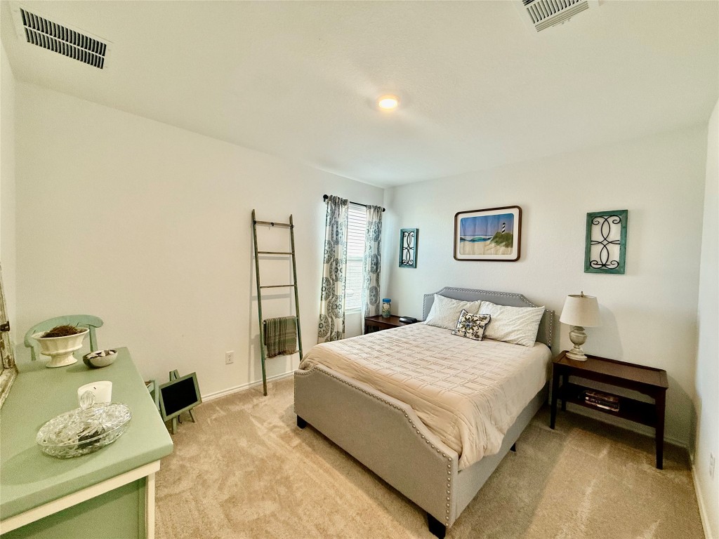 23521 Tiny Moons Way Elgin, TX 78621 - Photo 11 of 19 a bedroom with a bed and a window