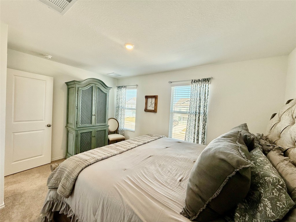 23521 Tiny Moons Way Elgin, TX 78621 - Photo 14 of 19 a bedroom with a bed and a window
