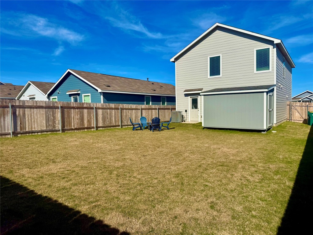 23521 Tiny Moons Way Elgin, TX 78621 - Photo 15 of 19 a front view of a house with a yard