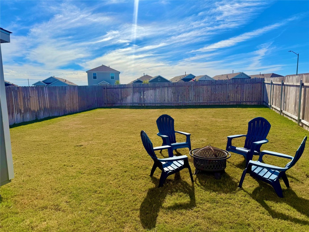 23521 Tiny Moons Way Elgin, TX 78621 - Photo 16 of 19 a view of a swimming pool with chair and table