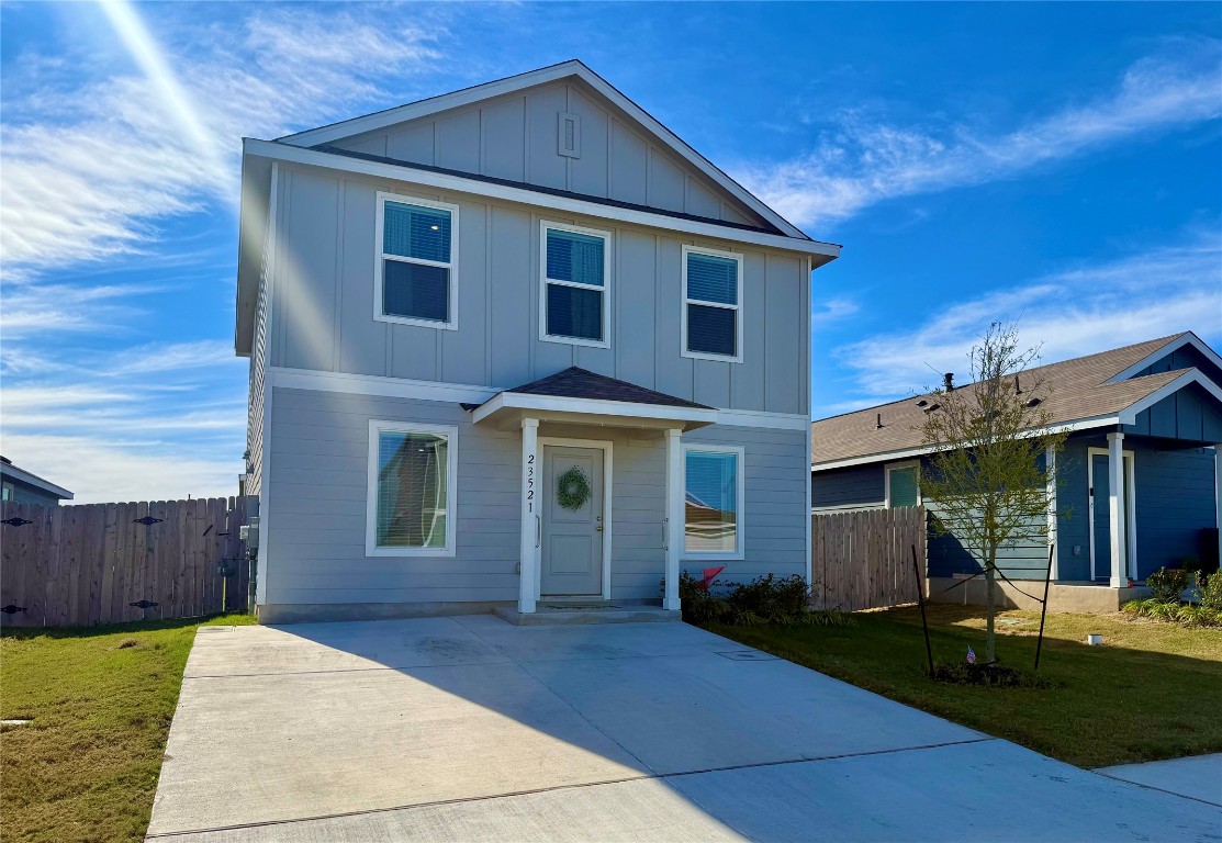 23521 Tiny Moons Way Elgin, TX 78621 - Photo 18 of 19 a front view of a house with garden