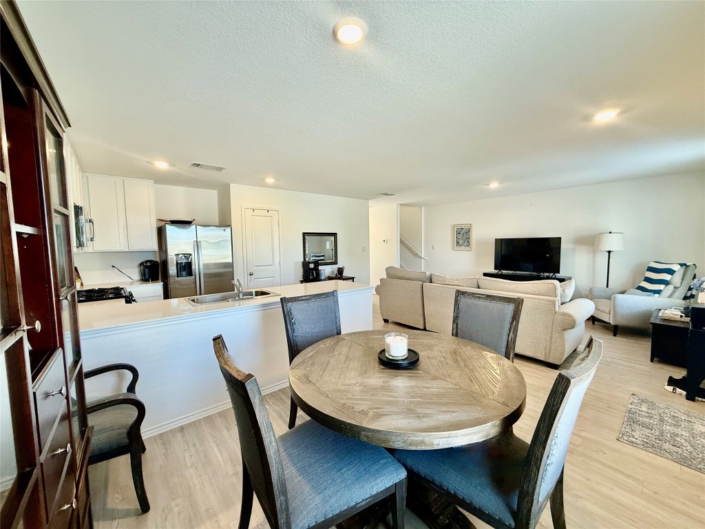 23521 Tiny Moons Way Elgin, TX 78621 - Photo 4 of 19 a view of a dining room with furniture and a kitchen