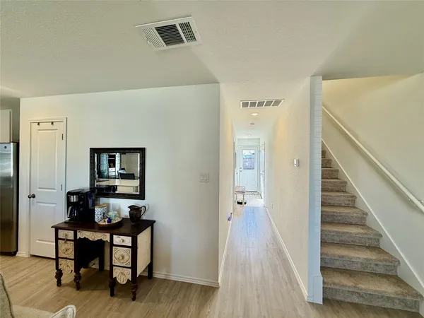 a kitchen with a refrigerator a microwave a sink and cabinets