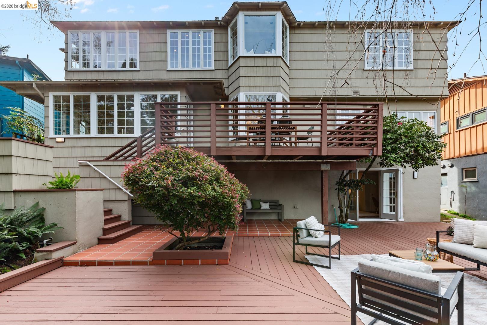 1123 Park Hills Road Berkeley, CA 94708 - Photo 40 of 47 a backyard of a house with wooden chairs and table on the patio