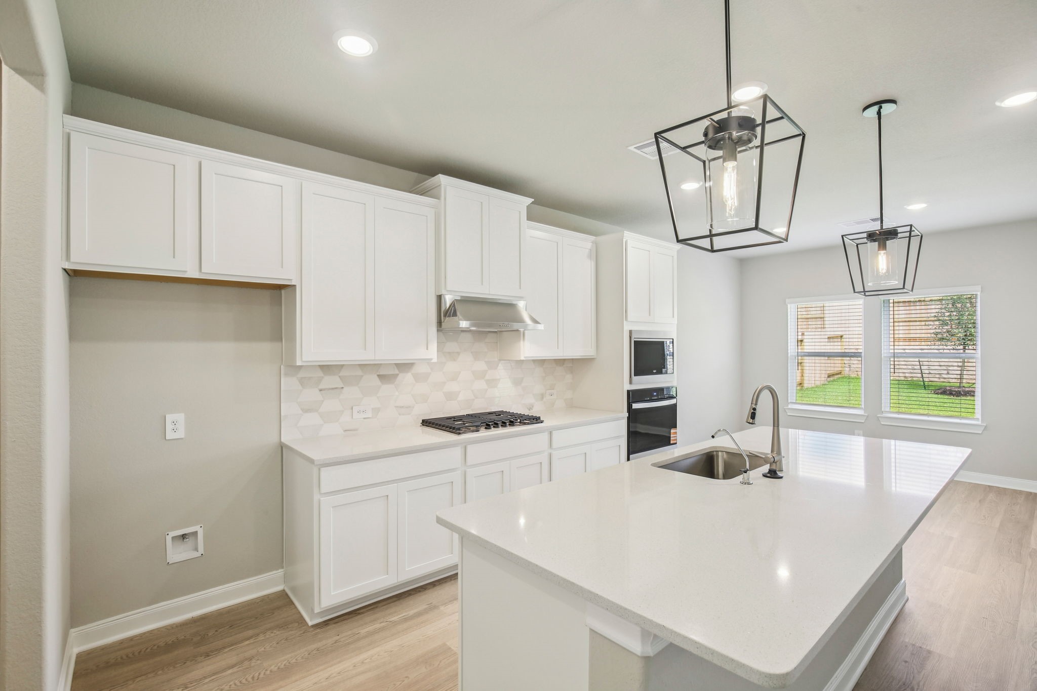 1660 Hopson Ranch Drive Conroe, TX 77301 - Photo 2 of 37 a kitchen with a sink a stove and cabinets