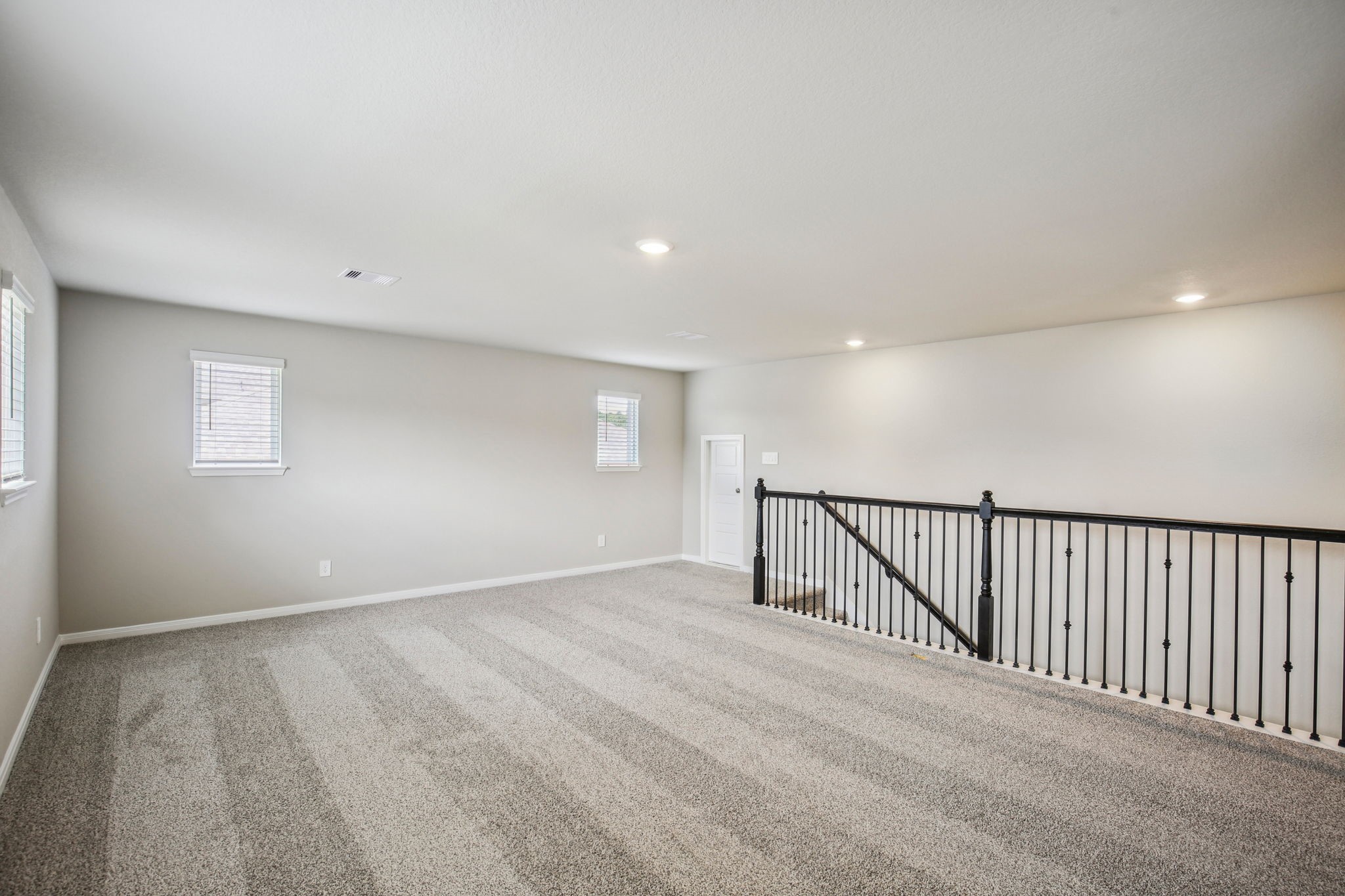 1660 Hopson Ranch Drive Conroe, TX 77301 - Photo 21 of 37 a view of an empty room with wooden floor