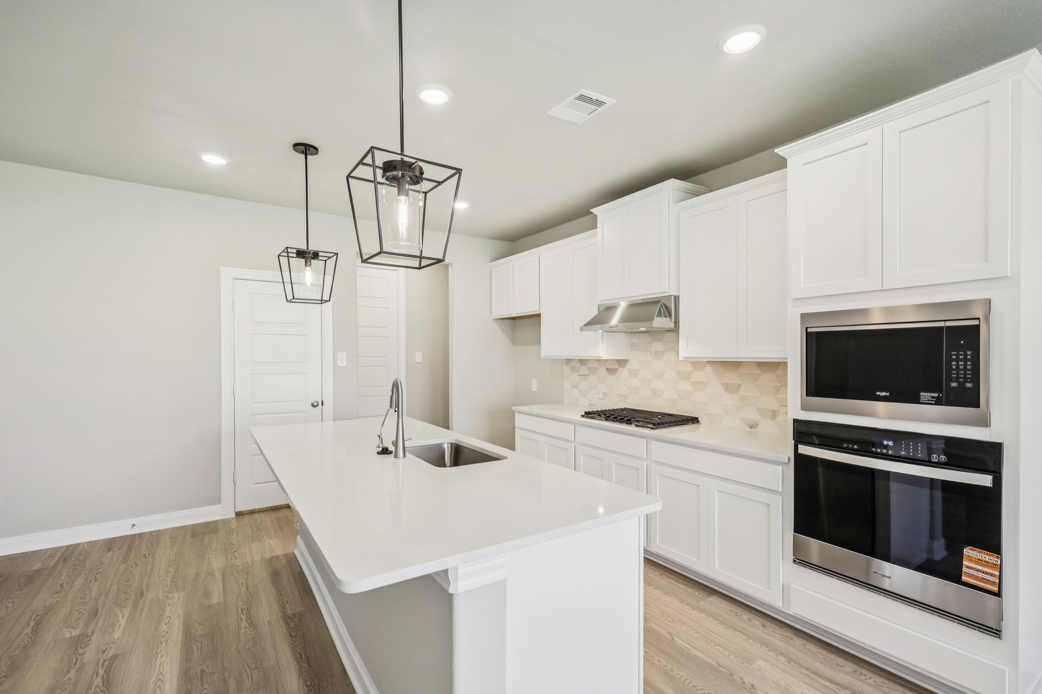 1660 Hopson Ranch Drive Conroe, TX 77301 - Photo 4 of 37 a kitchen with a sink a stove and refrigerator