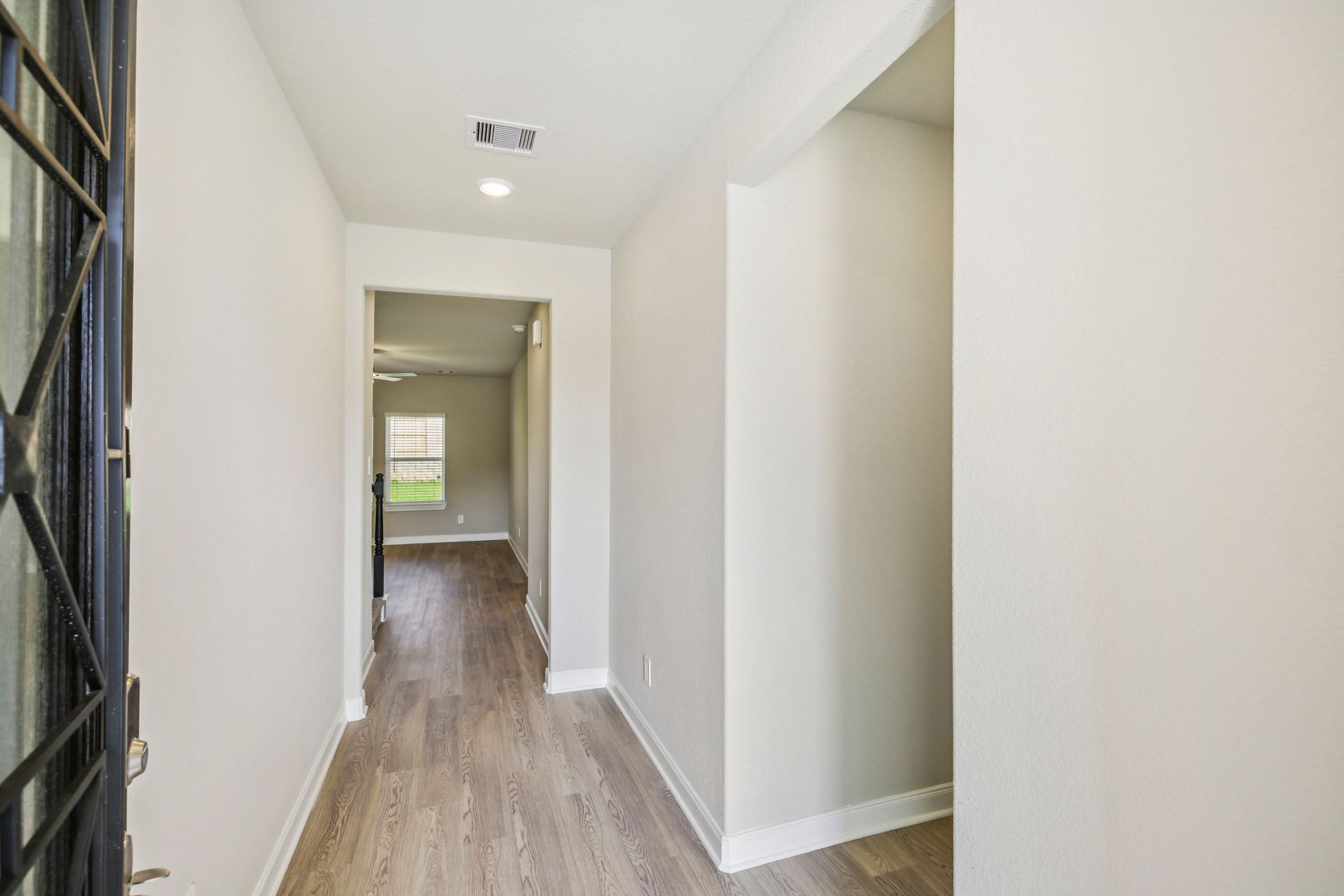 1660 Hopson Ranch Drive Conroe, TX 77301 - Photo 8 of 37 a view of a hallway with wooden floor