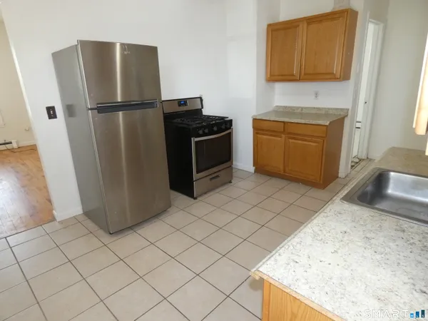 a kitchen with a refrigerator sink stove and cabinets