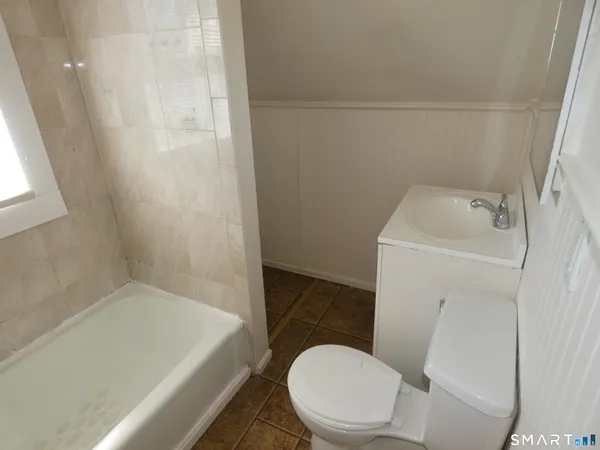 a bathroom with a toilet and a bathtub