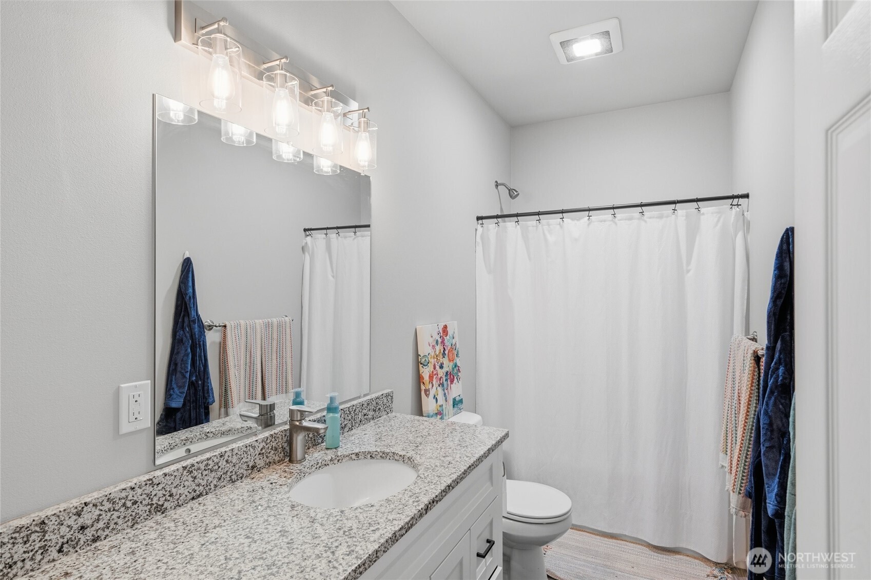 8470 Golden Valley Drive Maple Falls, WA 98266 - Photo 15 of 30 a bathroom with a granite countertop sink toilet and a mirror
